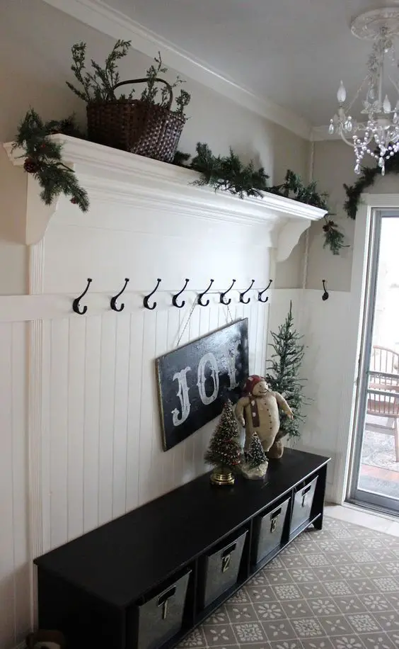 This is a simple foyer mudroom idea - love the special touches for Holiday / Christmas decorations.  Not sure this is enough to REALLY declutter all the stuff, but it's beautiful