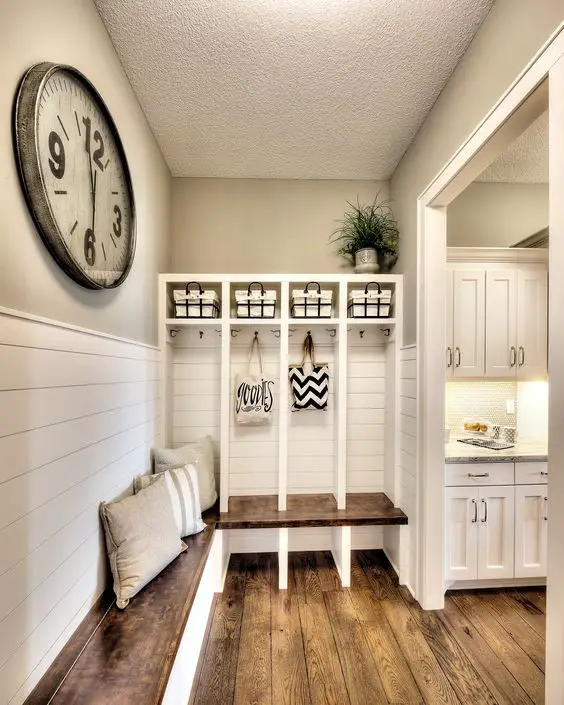 This DIY mudroom idea could be PERFECT for our house.  The separate section/cubbies are perfect for the kids to put their stuff so the house appears clutter-free and organized.  LOVE that big wall clock too and the pallet bench.