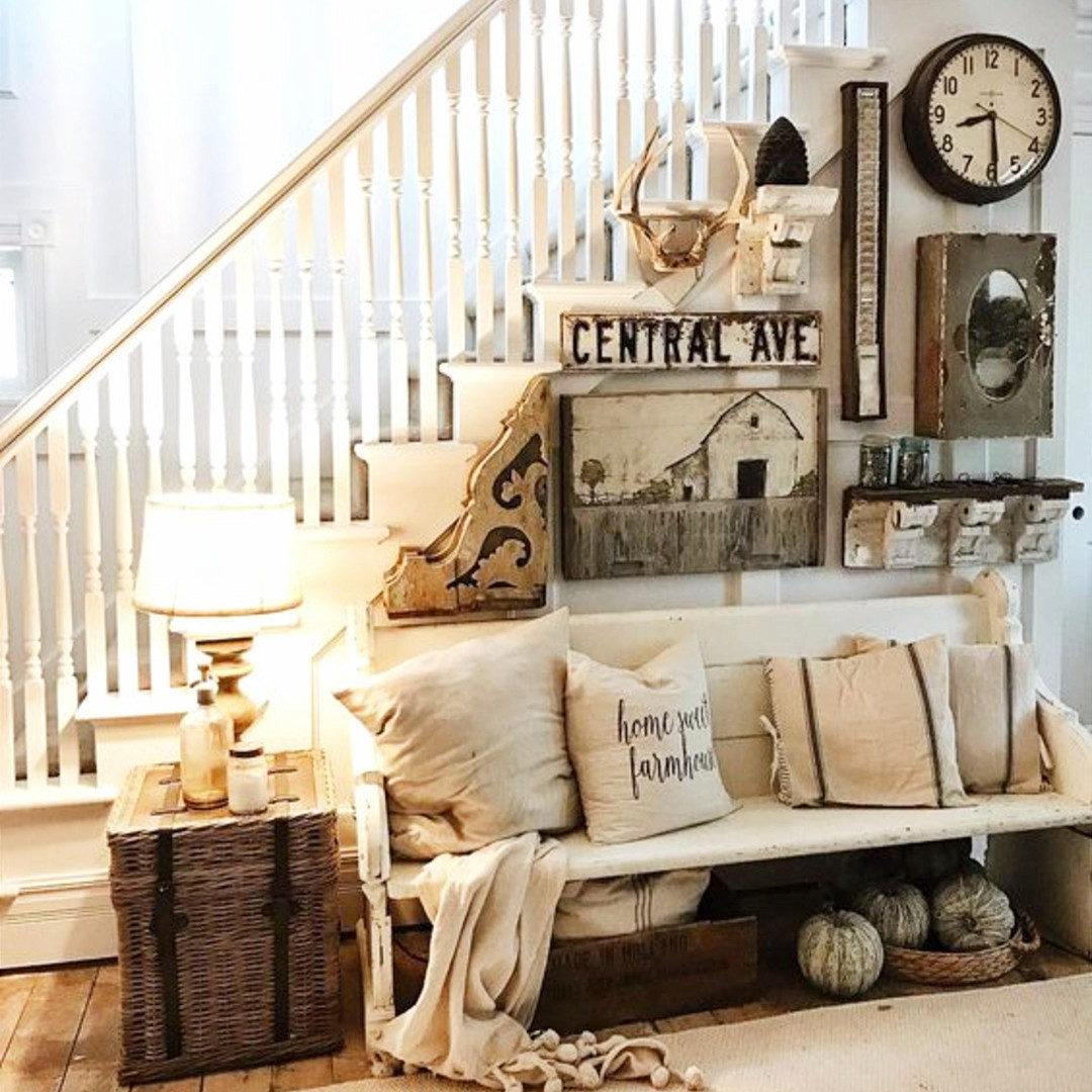 Love this farmhouse foyer idea - unique and eclectic gallery wall with interesting rustic decor items, a wood farmhouse bench that looks upcycled or reclaimed and repurposed to use as a furniture piece.  Great farmhouse entry way decorating 