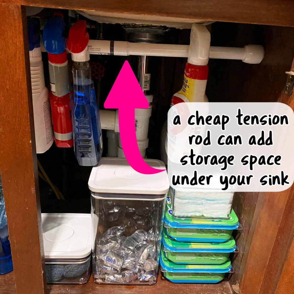 how to organize small apartment kitchens - under sink organization with a cheap tension rod