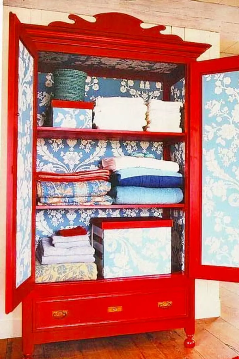 Repurpose an old cabinet or hutch to store towels, sheets and other linens