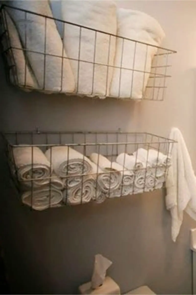 farmhouse style wire towel storage baskets on wall over toilet in bathroom